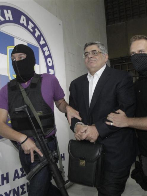 Far-right Golden Dawn party leader Nikos Mihaloliakos (centre) is escorted by anti-terrorism...