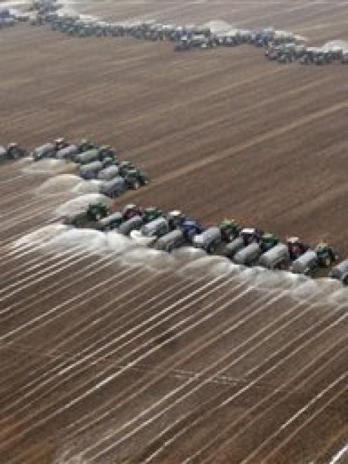 Farmers spray milk on a field in Ciney, Belgium, to underscore that European producers can't make...