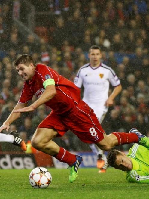 FC Basel's Tomas Vaclik (R) challenges Liverpool's Steven Gerrard during their Champions League...