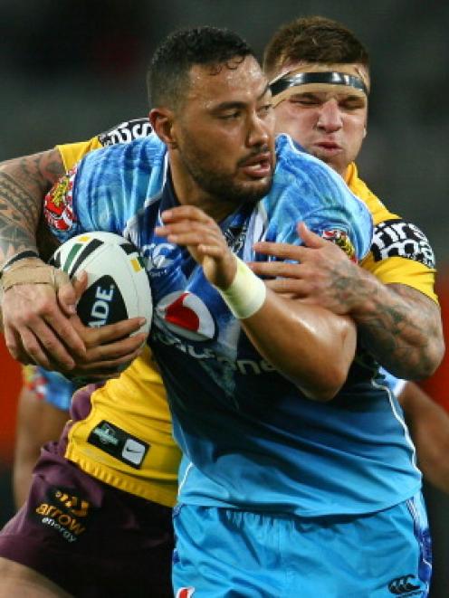 Feleti Mateo of the Warriors tries to break out of a tackle during the NRL trial match against...