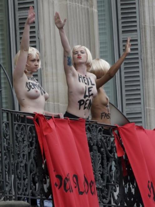 Femen activists give the Nazi salute to protest the speech by France's far-right National Front...