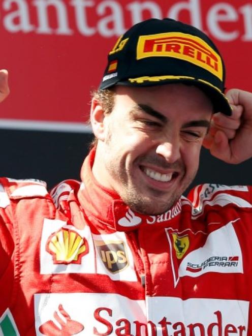 Ferrari driver Fernando Alonso of Spain celebrates after winning the Spanish F1 Grand Prix at the...