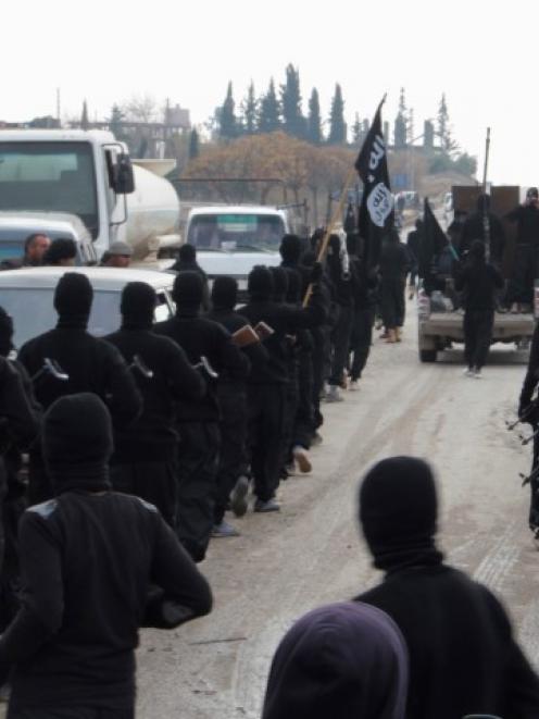 Fighters of al-Qaeda linked Islamic State of Iraq and the Levant parade at the Syrian town of Tel...