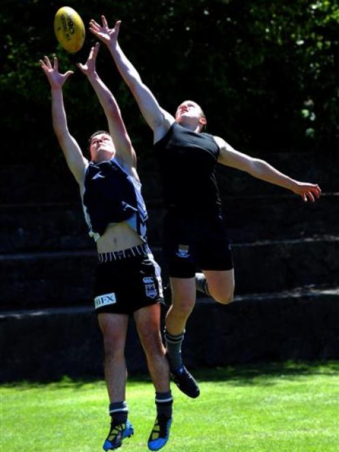 Fighting for the ball at Littlebourne yesterday are Otago Boys' High School pupils Chris McNoe ...