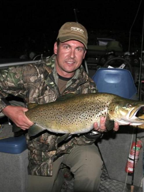 Film-maker Carl McNeil and a more than 5.5kg mouse-fed brown trout caught in Fiordland during...