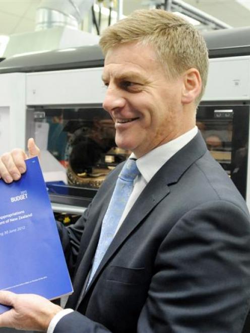 Finance Minister Bill English with the Budget he will present to Parliament today. Photo NZPA.