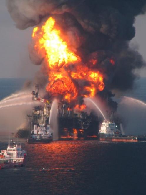 Fire boat response crews battle the blazing remnants of the offshore oil rig Deepwater Horizon,...