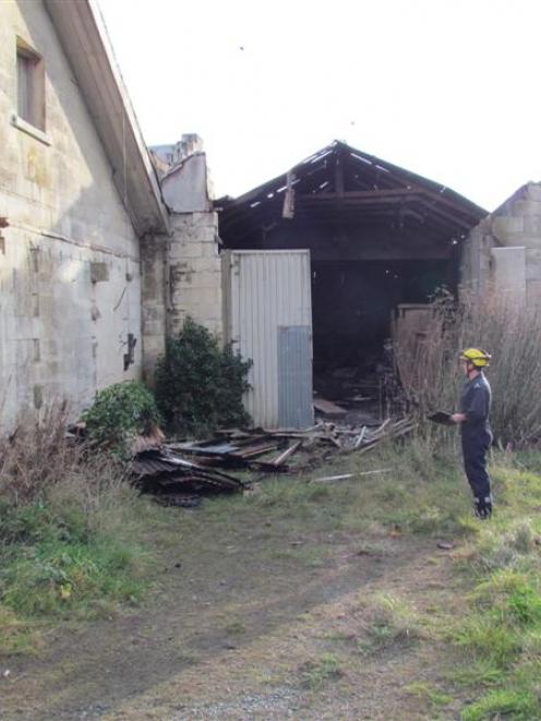 Fire inspector Paul Glanville, of Queenstown, yesterday  checks into a fire in the historic...