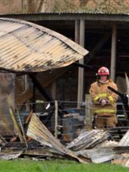 Fire investigators at the scene of a fatal house fire yesterday.  Photo by Gerard O'Brien.