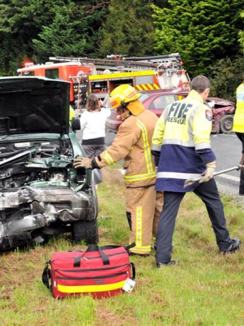 Fire Service personnel inspect an Isuzu Bighorn 4WD following a crash on Puddle Alley near...