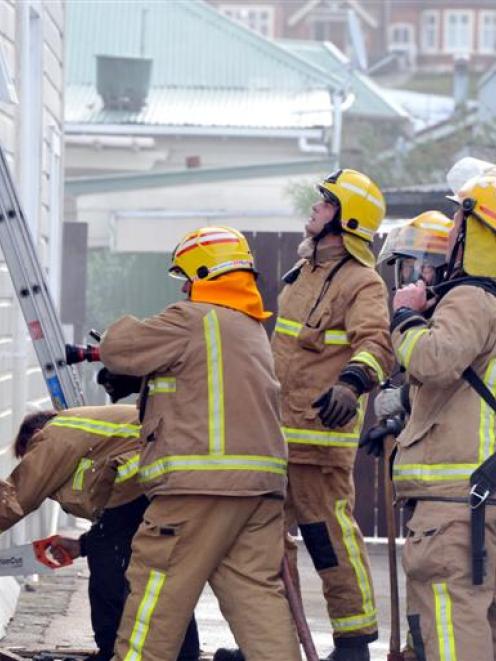 Firefighters at the scene of a house fire at Richmond St, Forbury, on Sunday evening.  Photo by...