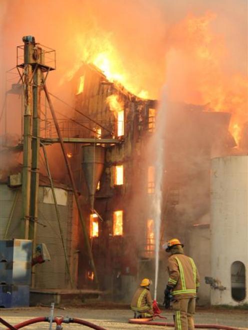 Firefighters attempt to control a fire at the Canterbury Flour Mill in Ashburton. Photo Ashburton...
