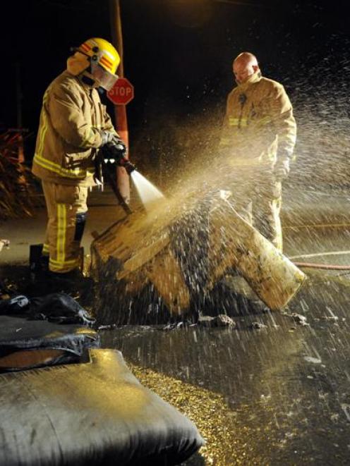 Firefighters dampen furniture on Castle St on Saturday night to prevent people setting fire to it...