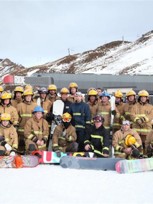 Firefighters walk up the slopes of Coronet Peak before competing in the K2 Climb on Friday. Photo...