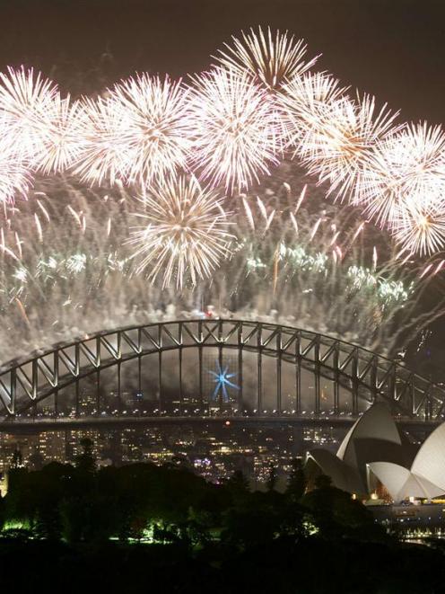 Fireworks explode over Sydney Harbour at midnight.  REUTERS/Jason Reed