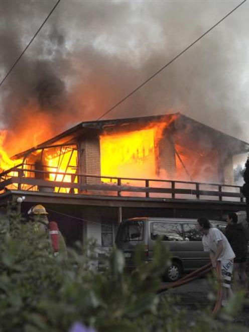 Flames erupt from a Somerville St, Dunedin, house last night. Photo by Peter McIntosh.