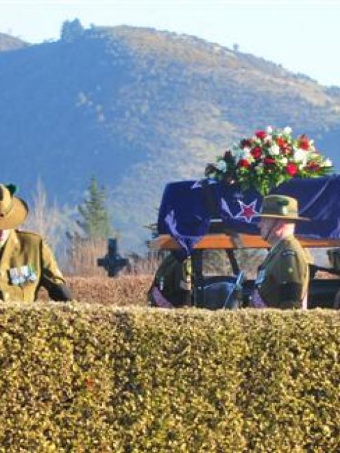 Flanked by army personnel, a gun carriage bearing the casket of Eric Batchelor arrives at Waimate...