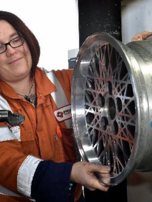 Fleur Sculpher lines up a mag wheel on Pryde Engineering's new wheel machine. PHOTO: GREGOR...
