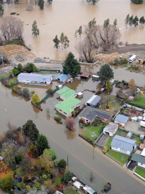 Flooded streets in Milton on Saturday, looking south to a   bend of the flooded Tokomairiro River...