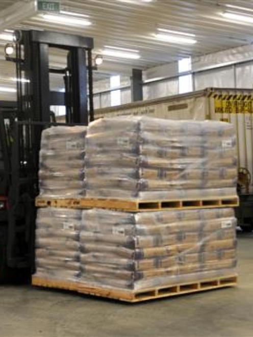 Fonterra forklift driver Shane Priest unloads milk powder from a train at the company's North...