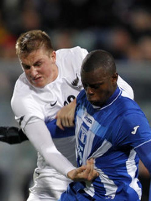 New Zealand's Chris Wood, left, competes for the ball against Honduras Erick Norales