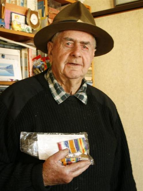Forbes Knight wears a ''lemon squeezer'' hat and holds his father's World War 1 ribbons as he...