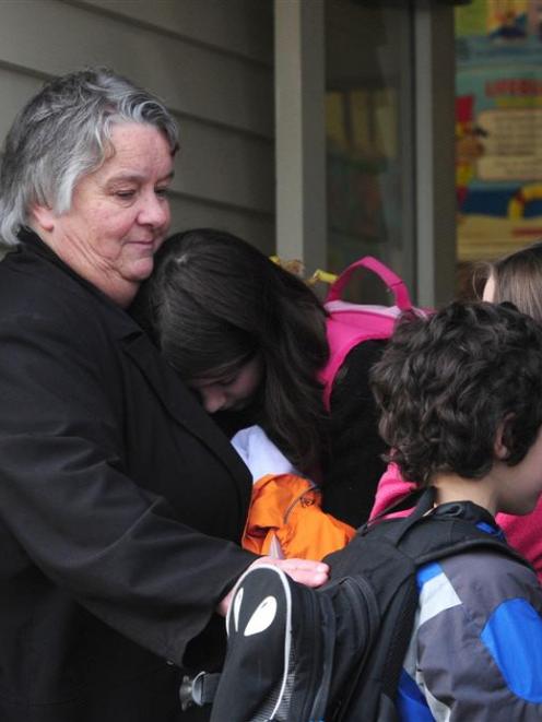 Forbury School principal Janice Tofia hugs Anastasia Ashley (12), while Nicolai Ashley (7) and...