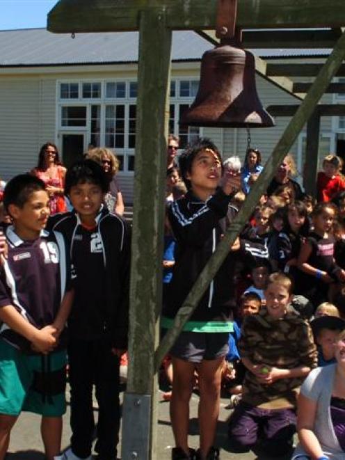 Forbury  School pupil Hamu Kereopa (10) rings the school bell for the last time, ending the...