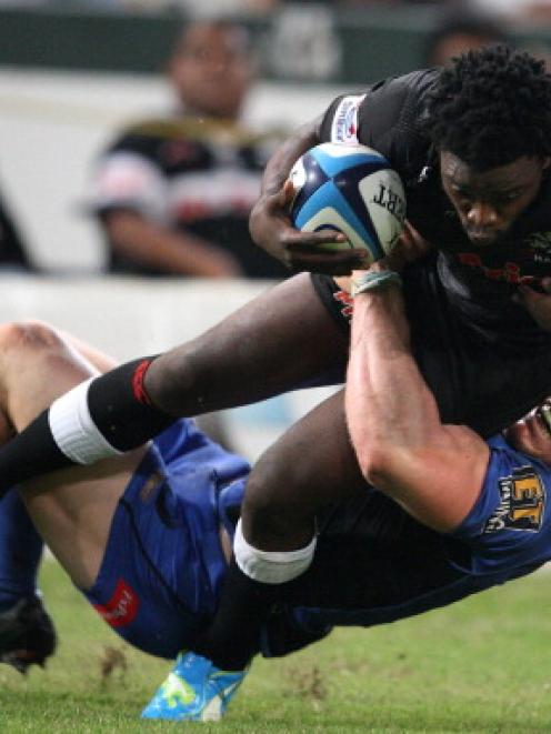 Force captain David Pocock tackles Lwazi Mvovo of the Sharks during their match in Durban, South...