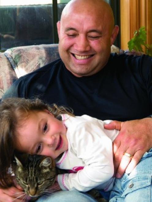 Former All Black Norm Hewitt, pictured with his daughter Elizabeth and cat Huna, in a photograph...