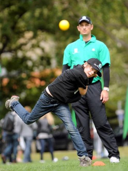 Former Black Caps fast bowler Shane Bond watches as Cameron Chapman, of Dunedin, sends down a...