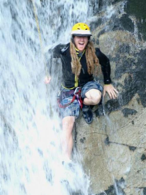 Former Dunedin man Mike Harris abseils down a Japanese waterfall.