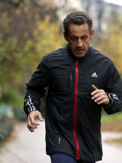 Former French President Nicolas Sarkozy jogs in Paris. Photo by Reuters