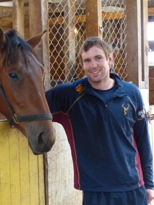 Former Highlanders rugby player Matt Saunders with 2yr-old pacer Franco Santiago at his West...