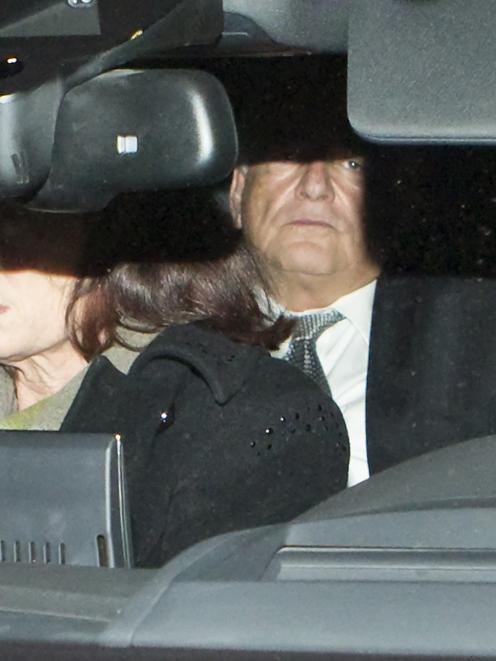 Former IMF head Dominique Strauss-Kahn (C) rides in the backseat of a car as he arrives at his...