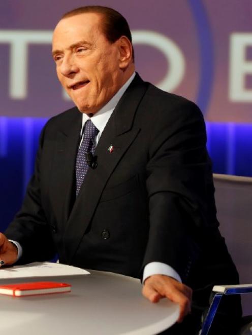 Former Italian prime minister Silvio Berlusconi sits before the taping of the talk show 'Otto e...