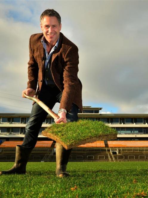 Former Otago rugby player and All Black Marc Ellis claims a piece of turf at Carisbrook yesterday...