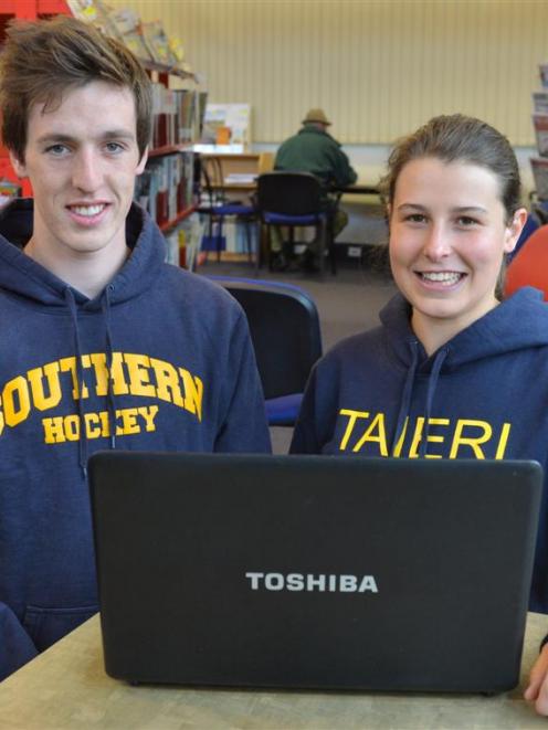 Former Taieri College pupils  Jarrod Casey and Hannah Grant check their NCEA results on a  laptop...