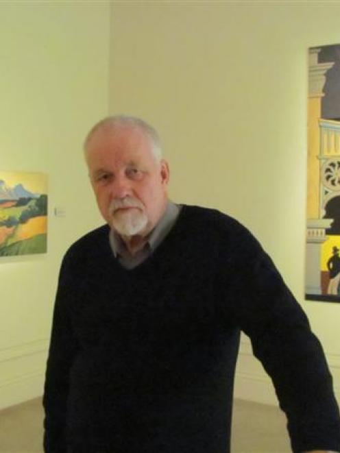 Forrester  Gallery director Warwick Smith with two  works by Colin Wheeler. Photo by Andrew Ashton.