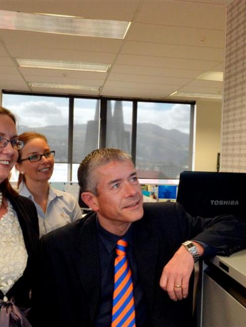 Forsyth Barr brokers (from left) Suzanne Kinnaird, Haley Van Leeuwen and Tom Bliss watch the...