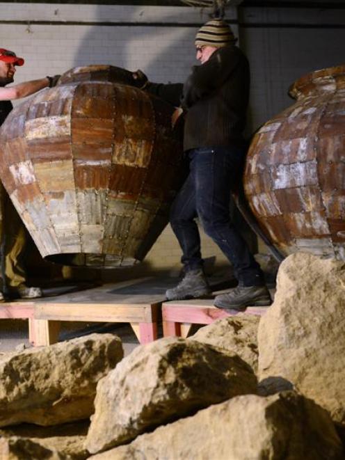 Fortune Theatre set designers Matt Best (left) and Peter King load pots into the Standard...