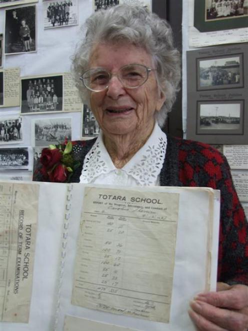 Caroline Frame (nee Sherwin) displays one of her old school reports during Totara School's 125th...