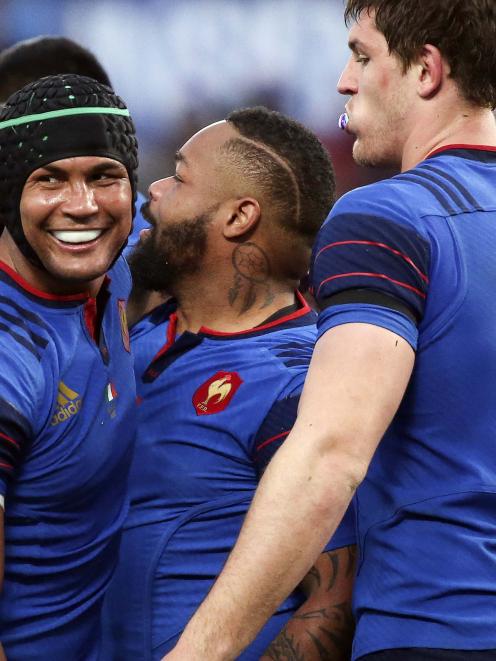 France's Bastareaud celebrates with teammates Dusatoir and Flanquart after scoring a try against...