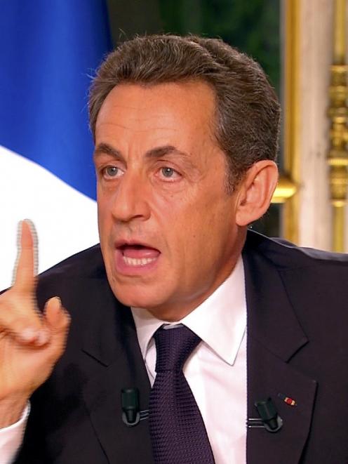 France's President Nicolas Sarkozy, seen in this video grab from TF1 French television in a prime...