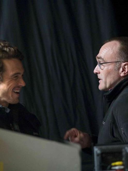 Franco, (left) and director Danny Boyle talk on the set of <i>127 Hours</i>.