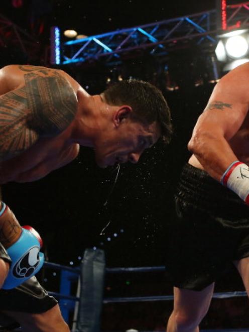 Francois Botha (L) takes on Sonny Bill Williams in their heavyweight bout at the Brisbane...
