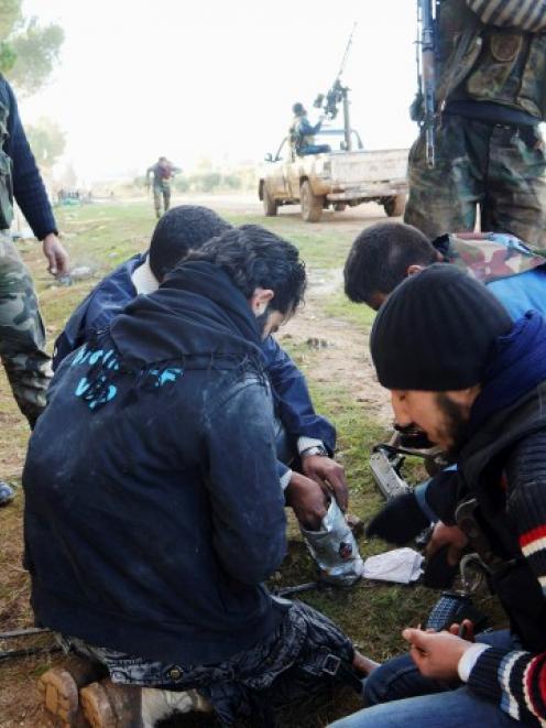 Free Syrian Army fighters prepare their weapons in Aleppo's al-Amereya district. REUTERS/Saleh...