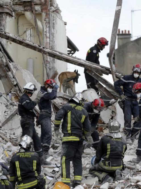 French firefighters search the rubble of a collapsed building in Rosny-Sous-Bois, near Paris....