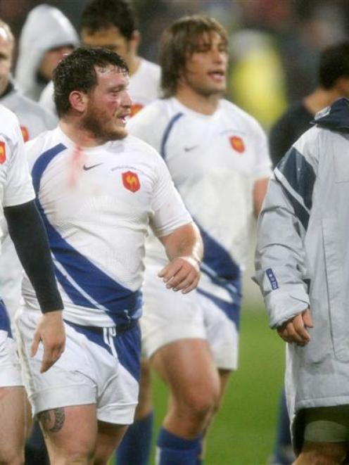 French players leave the field dejected after their loss against New Zealand in the international...
