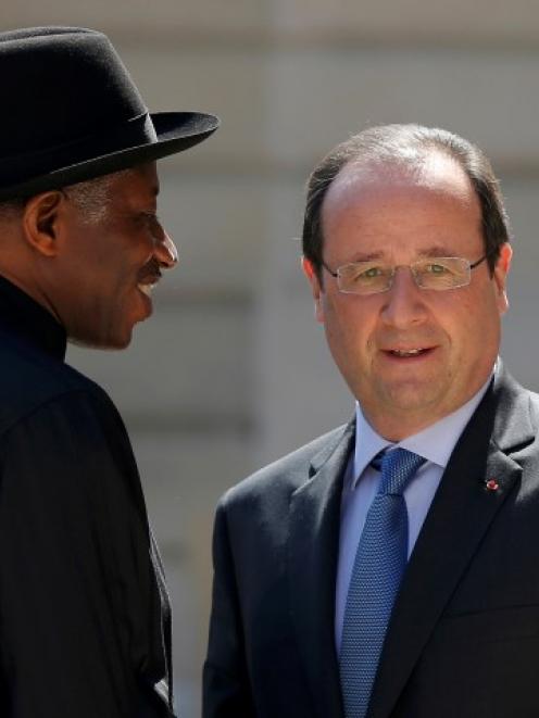 French President Francois Hollande (R) welcomes Nigerian President Goodluck Jonathan as he...